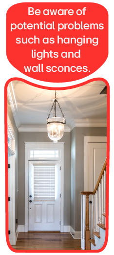 A staircase with a low-hanging ceiling light. Be aware of potential problems such as hanging lights and wall sconces.